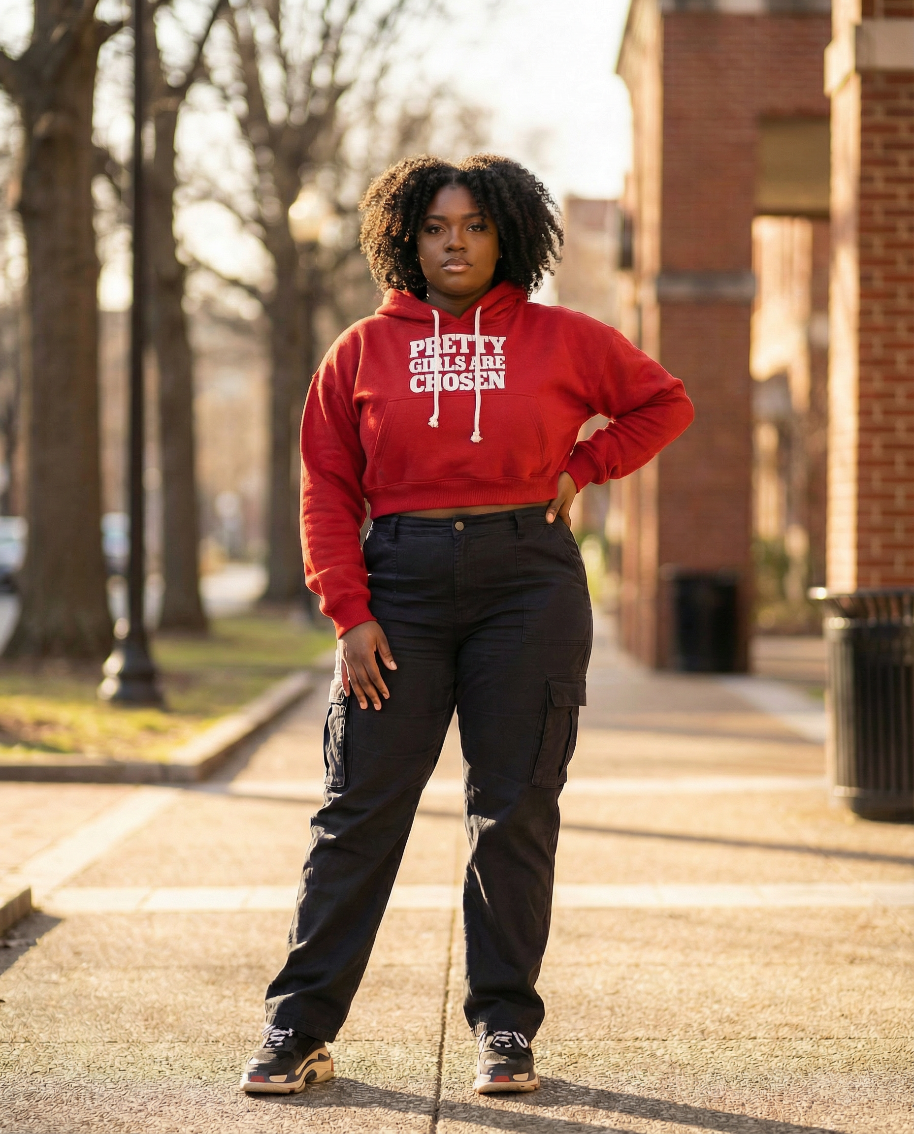 Girl wearing red cropped BAHAR "Pretty Girls Are Chosen" hoodie.